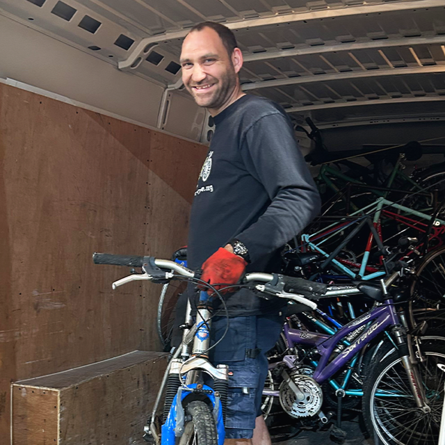 Ryan unloading bike donation re-cycle