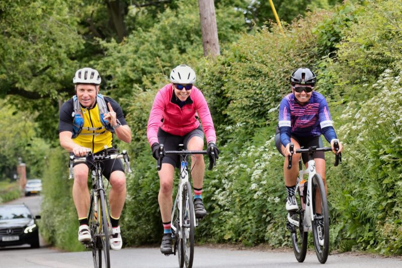 Charity Cycle Ride cyclists donate money