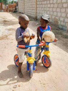 The Gambia 2024 - Young boys with balance bikes